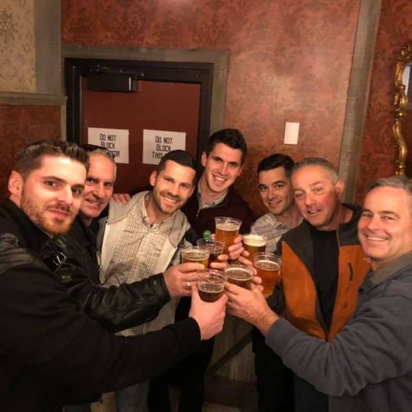 a group of people sitting at a table with wine glasses