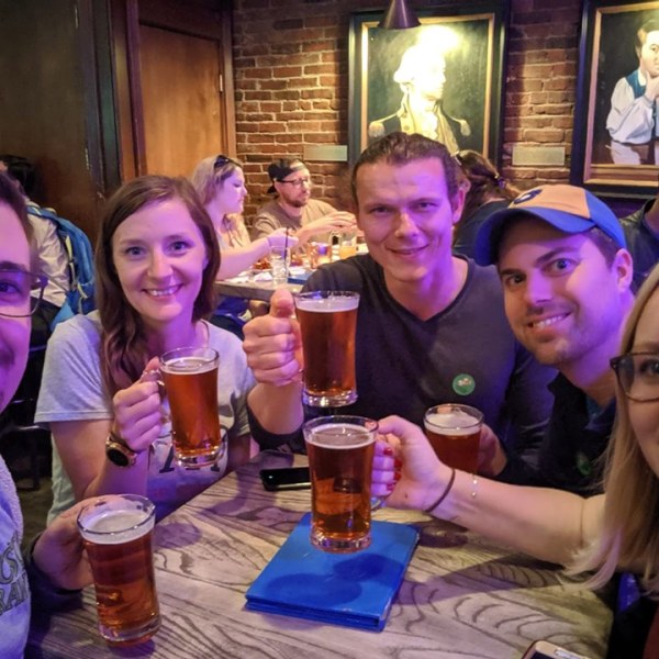 Cari Lekebusch et al. sitting at a table posing for the camera
