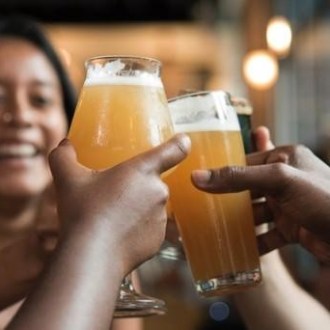 a hand holding a glass of orange juice