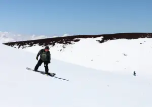 a man riding skis down a snow covered slope